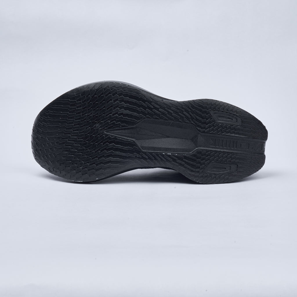 Black athletic shoe sole on a light gray background