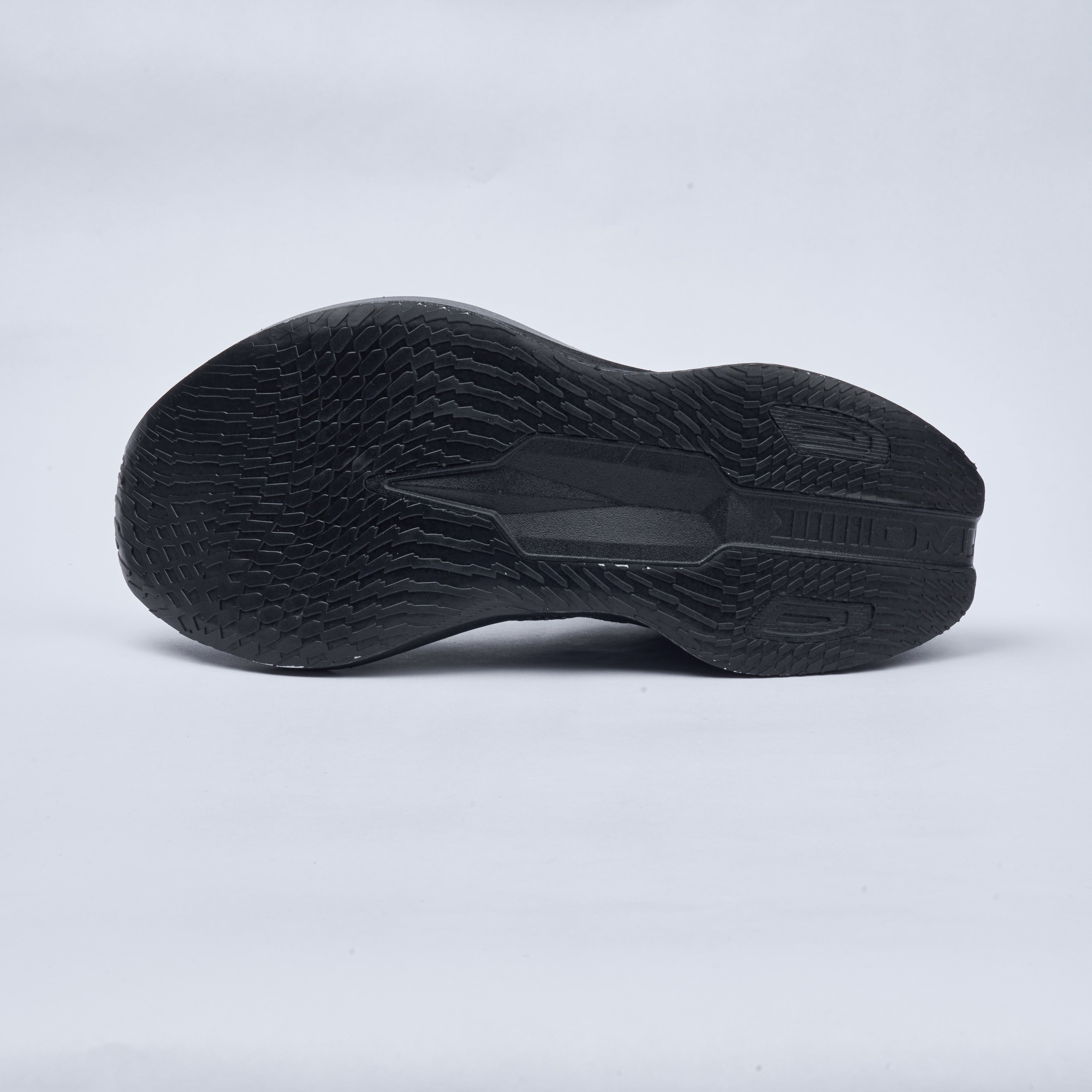 Black athletic shoe sole on a light gray background